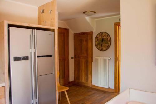 a kitchen with a refrigerator in a room at Maison Carrel Elegant 4 in Breuil-Cervinia