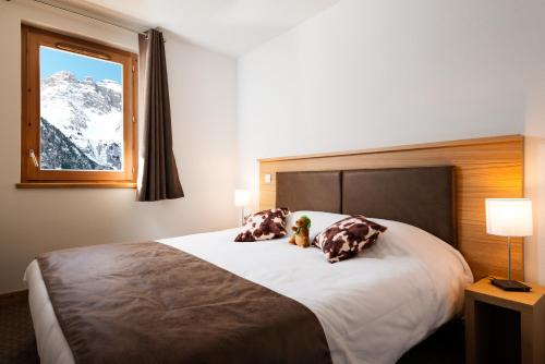 Кровать или кровати в номере Lagrange Vacances Les Hauts de la Vanoise