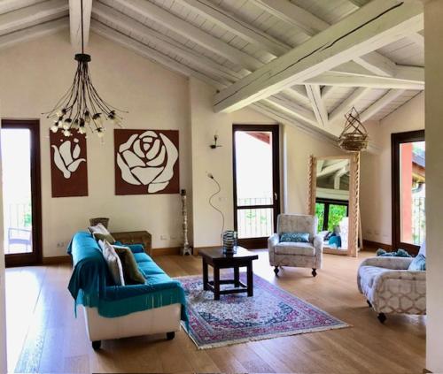 a living room with a blue couch and a chair at Tenuta La Quassa in Ispra