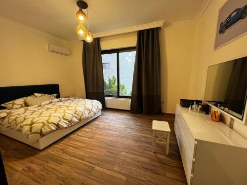 a bedroom with a bed and a large window at MaisonGaia, A Stylish Apartment in the heart of Amman in Amman