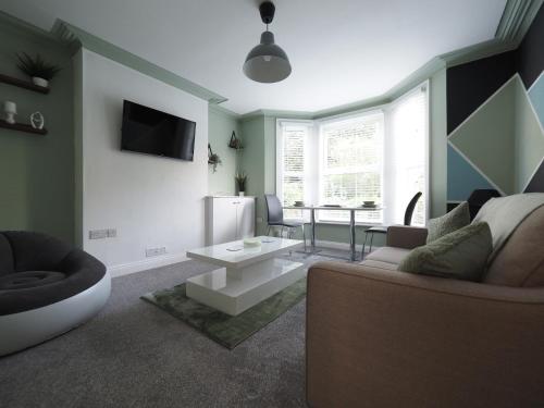 a living room with a couch and a table at Grosvenor Suite in Royal Tunbridge Wells