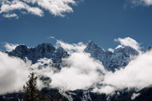 a mountain range with clouds in front of it at Chalet Sofija in Gozd Martuljek