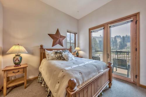 a bedroom with a bed and a large window at Kirkwood Mountain Resort Properties in Kirkwood