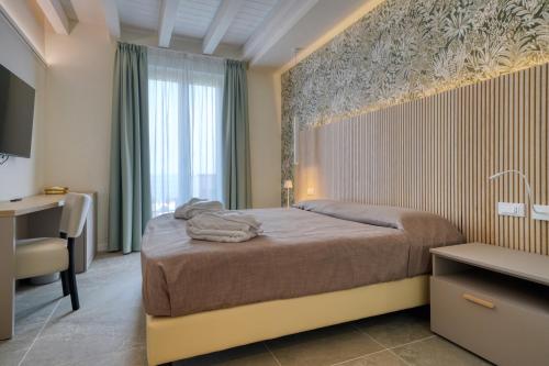 Posteľ alebo postele v izbe v ubytovaní Hotel Palazzo del Garda & Spa