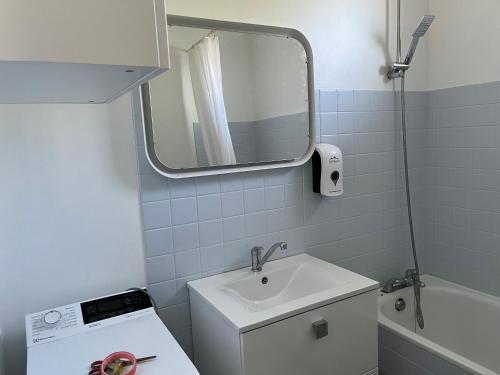 a small bathroom with a sink and a mirror at Partisole in Garéoult