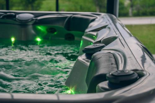 a ride in a pool of water with green lights at Villa Tasnim in Dobrenica