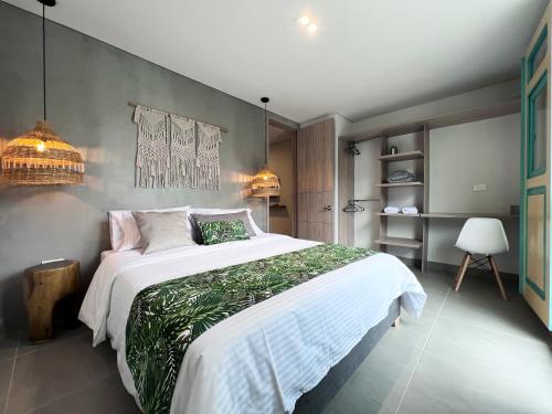a bedroom with a large white bed with plants on it at Parallelo Loft Salento P2 in Salento