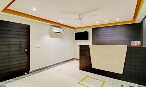a lobby with two wooden doors and a television at Treebo ASL Prime, Gariahat in Kolkata
