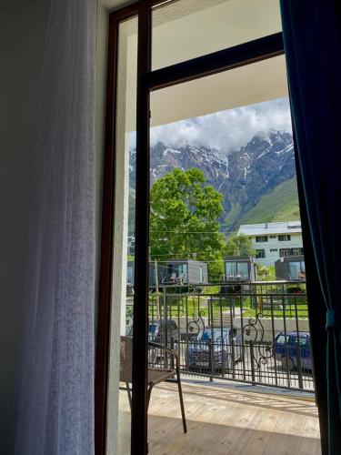 a room with a window with a view of a mountain at Mood Hotel Kazbegi in Stepantsminda