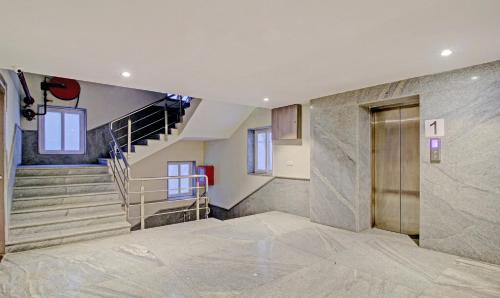 an empty lobby with a staircase and a door at Treebo ASL Prime, Gariahat in Kolkata