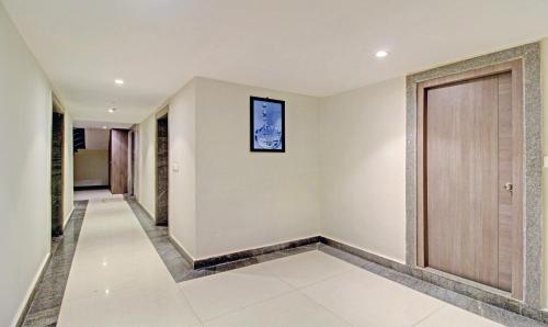 a hallway of a house with a door at Treebo ASL Prime, Gariahat in Kolkata