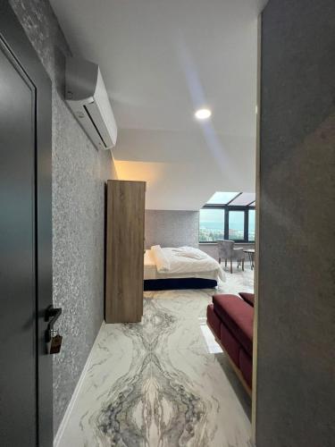 a room with a bed and a door with a marble floor at Melissa Suite in Trabzon