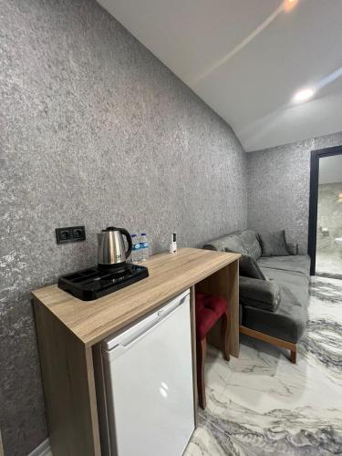 a kitchen with a table and a couch in a room at Melissa Suite in Trabzon
