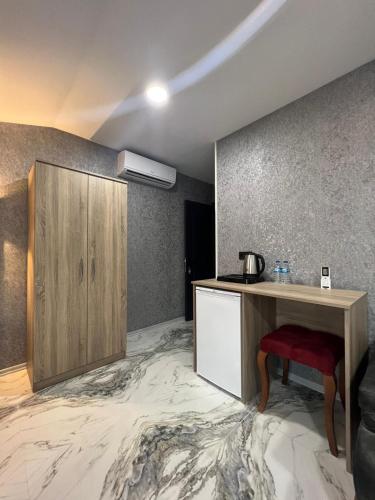 a room with a kitchen with a counter and a table at Melissa Suite in Trabzon