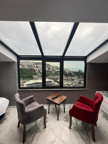 a room with two chairs and a table in front of a window at Melissa Suite in Trabzon