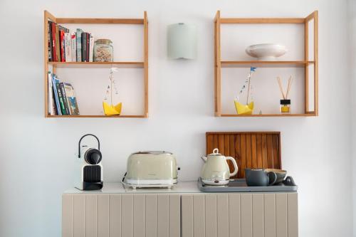 a kitchen counter with a toaster and some shelves at GM House Minorca in Cala en Bosc