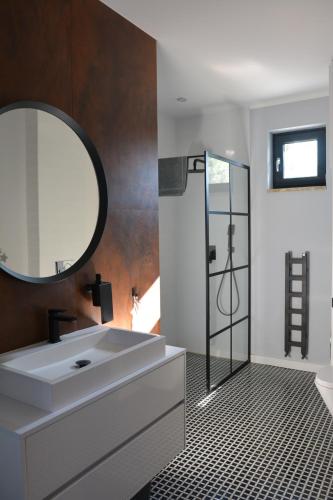 a bathroom with a white sink and a mirror at Luksusowa Willa Mechelinki in Mechelinki