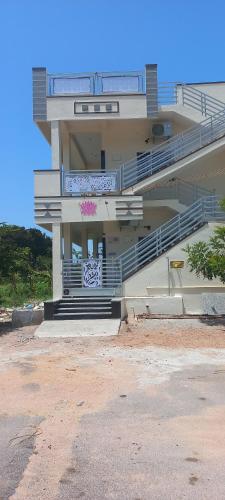 a building with stairs and a pink graffiti on it at Aditya Tourist Home in Hampi
