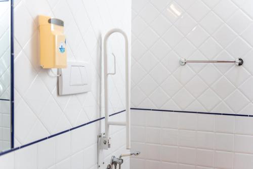 a bathroom with a yellow soap dispenser on the wall at Appartamento Falegnameria in Laterina
