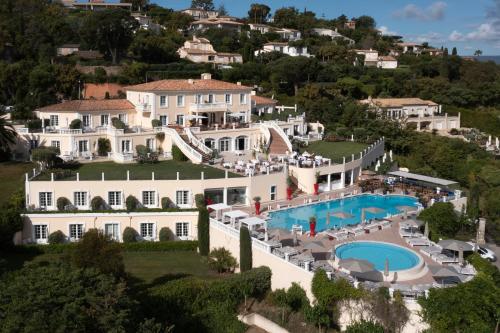 an aerial view of a mansion with a swimming pool at Althoff Hotel Villa Belrose in Saint-Tropez