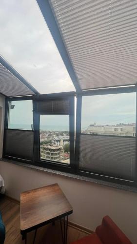 a room with a window with a table and a view at Melissa Suite in Trabzon