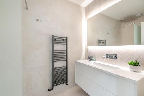a bathroom with a sink and a mirror at Entire Garden Flat with Parking - Portobello Road in London