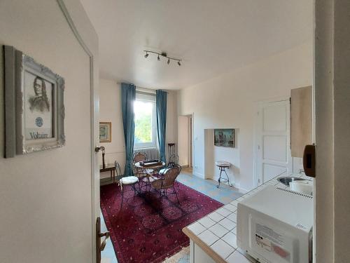 a kitchen and living room with a table and chairs at Manoir Petit Meysset in Sarlat-la-Canéda