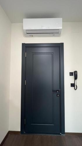 a black door in a room with a ceiling at Melissa Suite in Trabzon