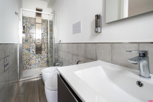 a bathroom with a sink and a toilet and a shower at Ammare Bed & Breakfast in Marina di Camerota