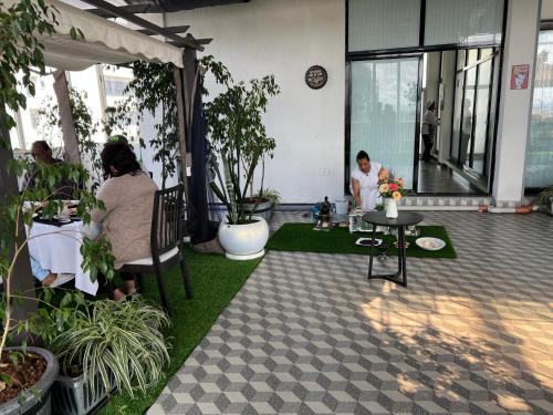 a group of people sitting at tables in a building at ECCO Modern Guest House in Addis Ababa