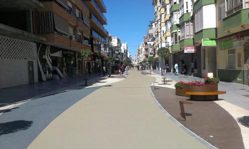 an empty street in a city with buildings at Apartamentos Turisticos Las Yucas in Torre del Mar