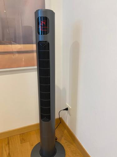 a tall metal object sitting on the floor next to a wall at Loft Crocetta in Turin