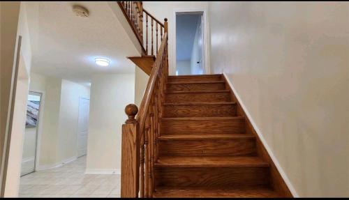 a staircase in a home with wooden steps at Super Huge Comfortable King Bedroom near Toronto Pearson Airport in Mississauga