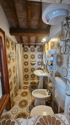 a bathroom with a sink and a toilet in it at La Corte in Marciana Marina
