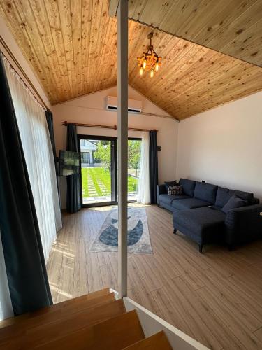 a living room with a couch and a wooden ceiling at Sea Life Homes in Kemer