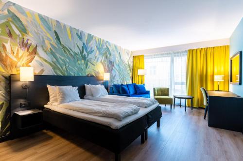 a bedroom with a bed and a painting on the wall at Thon Hotel Ålesund in Ålesund