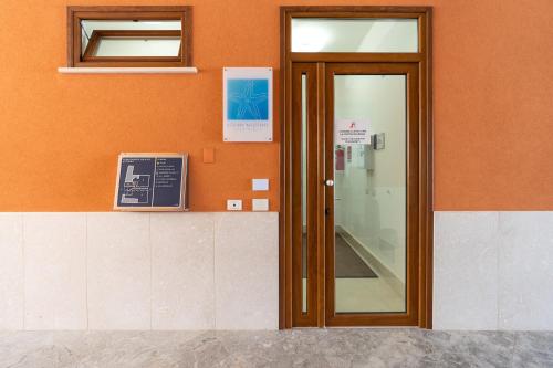 a door in a building with an orange wall at Appartamento I Mori sea view in Balestrate