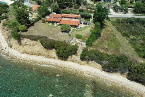an aerial view of a house next to the water at Alterra Vita Captain's Cabin in Neos Marmaras