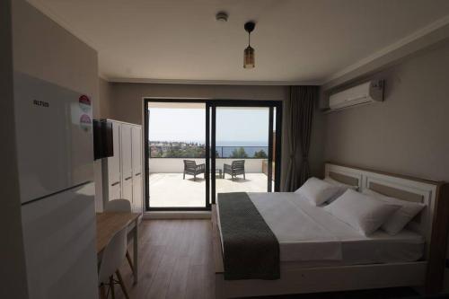 a bedroom with a bed and a view of a patio at Royal Homes 501 in Antalya