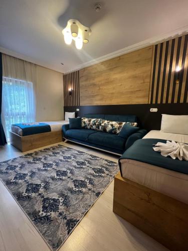 a bedroom with two beds and a rug at Mego Suite Otel in Uzungöl