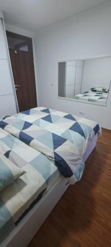 a bed in a room with a mirror at Street C apartment nr 1 in Pristina