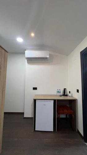 a kitchen with a table and a refrigerator in a room at Melissa Suite in Trabzon