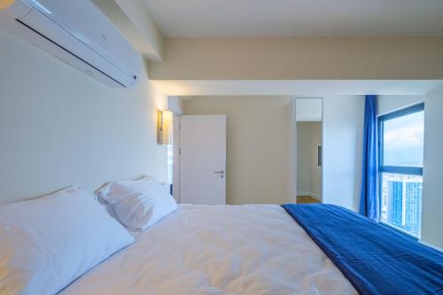 a white bed in a room with a window at Batumi River Source in Batumi