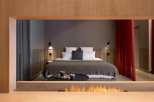 a bedroom with a bed with a red curtain at MiHotel Sala in Lyon