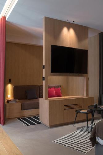 a living room with a couch and a flat screen tv at MiHotel Sala in Lyon