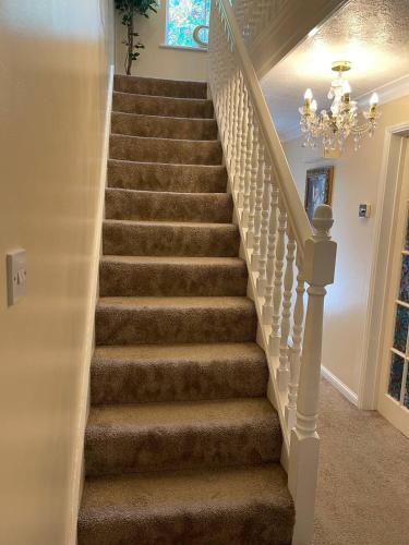 a set of stairs in a home with a chandelier at 1 small double room in a cul de sac classy area in a shared house in Bristol