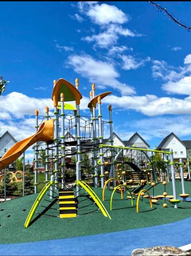a playground with a slide in a park at Beautiful 2 bedroom home away from home in Calgary