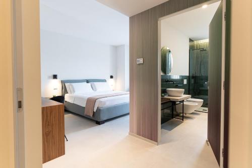 Postel nebo postele na pokoji v ubytování MORUS Urban Suites