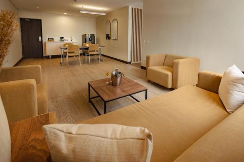 a living room with a couch and chairs and a table at SHG Liv Zona G Hotel in Bogotá