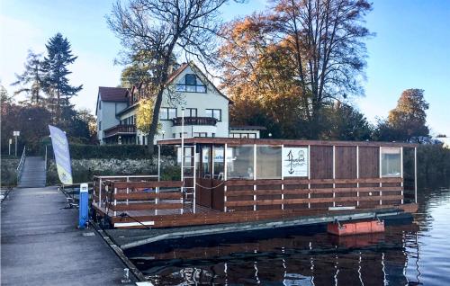 a house boat is docked at a dock at Amazing Ship In Neuruppin With Wifi in Neuruppin